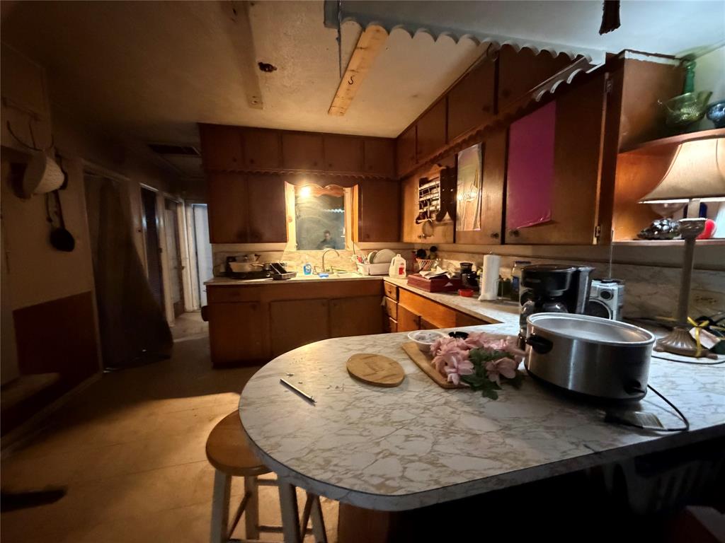 5054 Flamingo Road Fort Worth, TX 76119 - Photo 5 of 15 a kitchen with stainless steel appliances granite countertop a sink a stove and a refrigerator