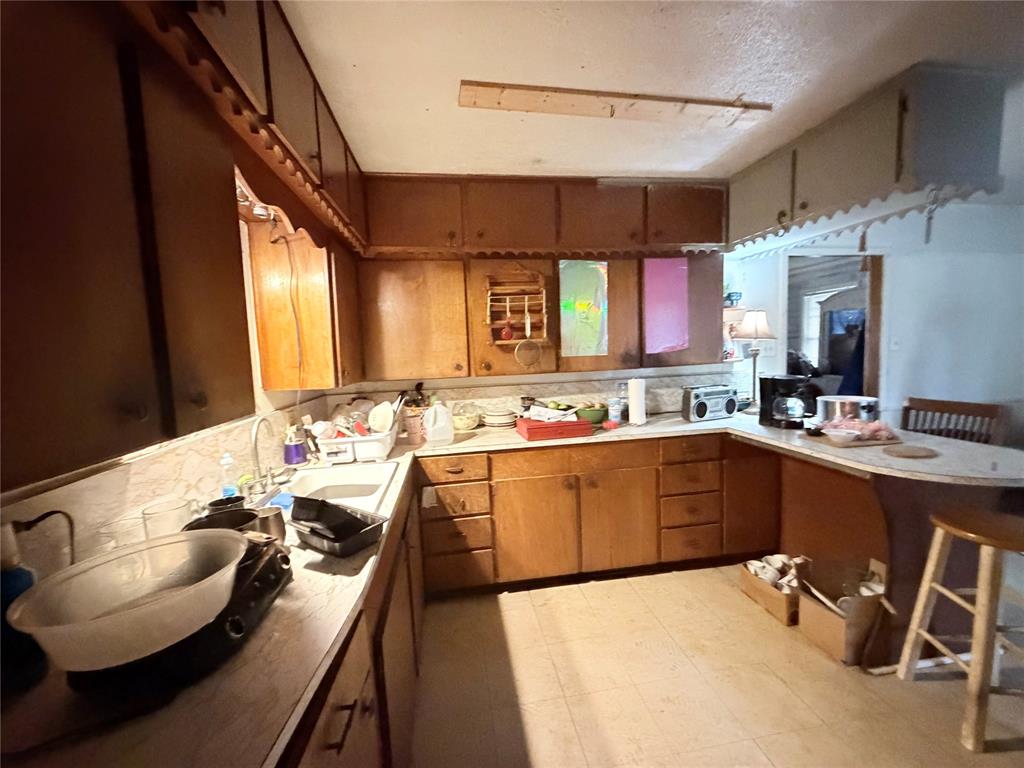 5054 Flamingo Road Fort Worth, TX 76119 - Photo 6 of 15 a large kitchen with a table and chairs in it