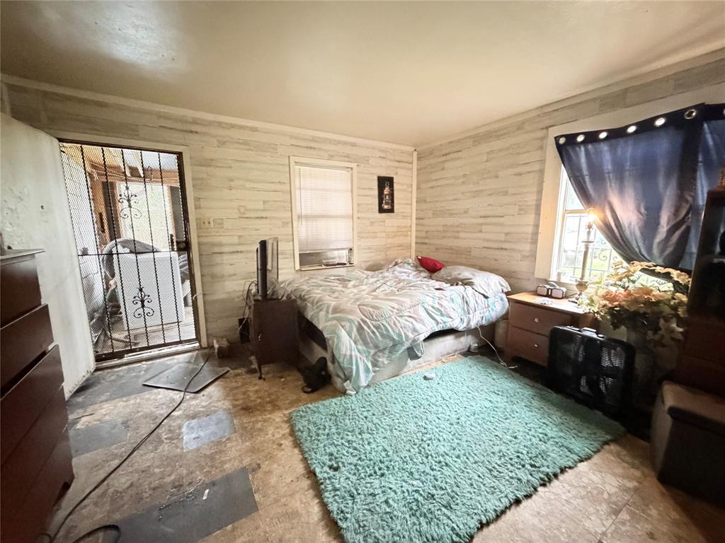 5054 Flamingo Road Fort Worth, TX 76119 - Photo 7 of 15 a bedroom with a bed a dresser and a window