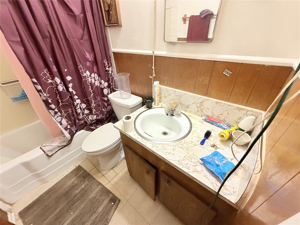 5054 Flamingo Road Fort Worth, TX 76119 - Photo 8 of 15 a bathroom with a sink a mirror and toilet