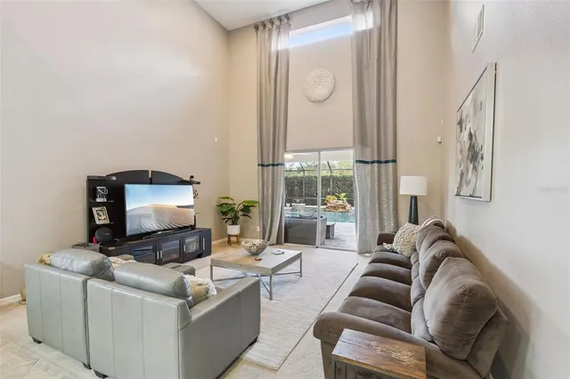 a living room with furniture and a mirror