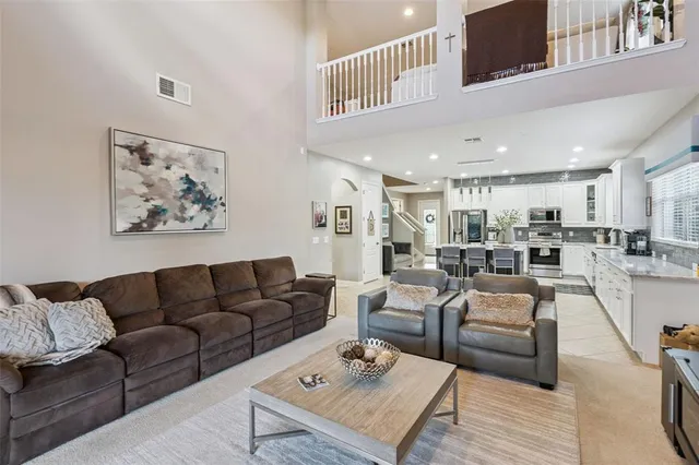 a living room with furniture kitchen view and a table