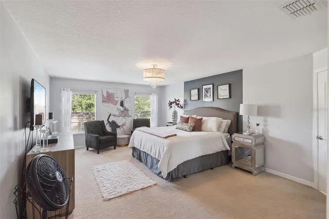 a bed room with a bed and a large window