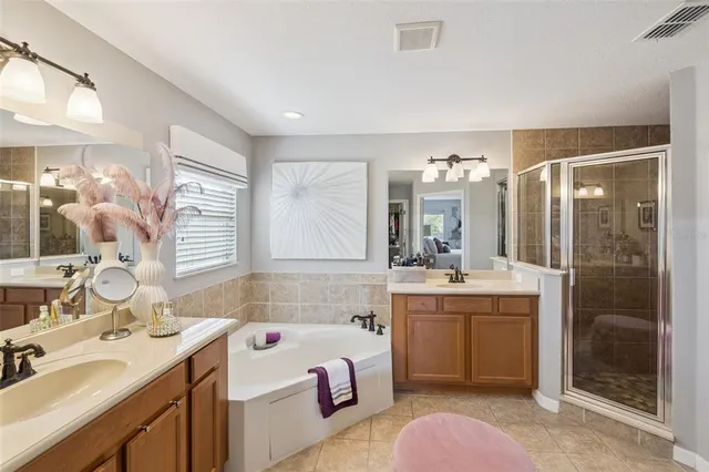 a bathroom with a granite countertop sink mirror and a bathtub