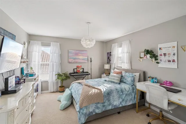 a bedroom with a bed furniture and a large window