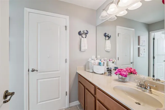 a bathroom with a sink vanity and a mirror