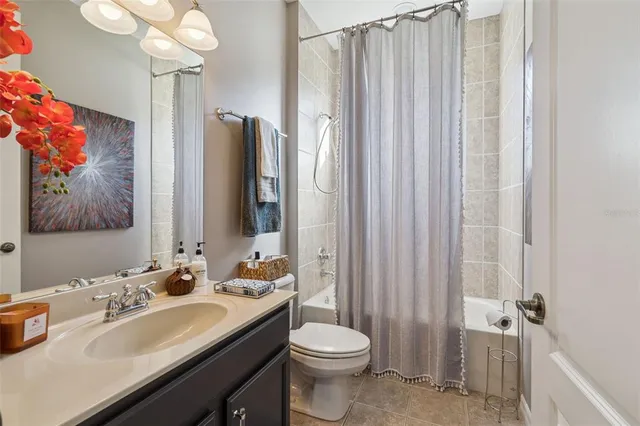 a bathroom with a sink vanity mirror and toilet