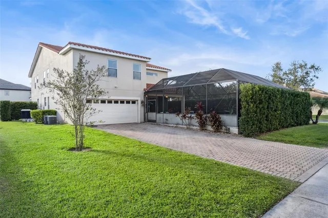 a view of a house with backyard and a tree