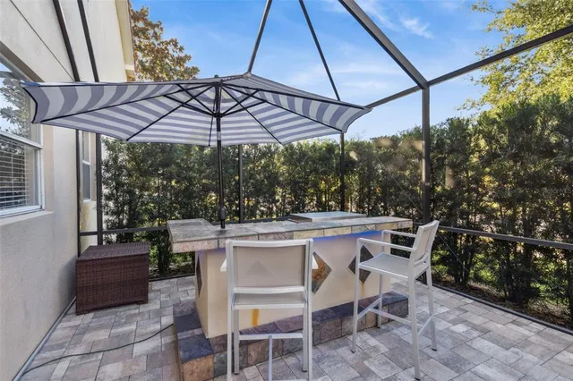 a view of a patio with table and chairs under an umbrella