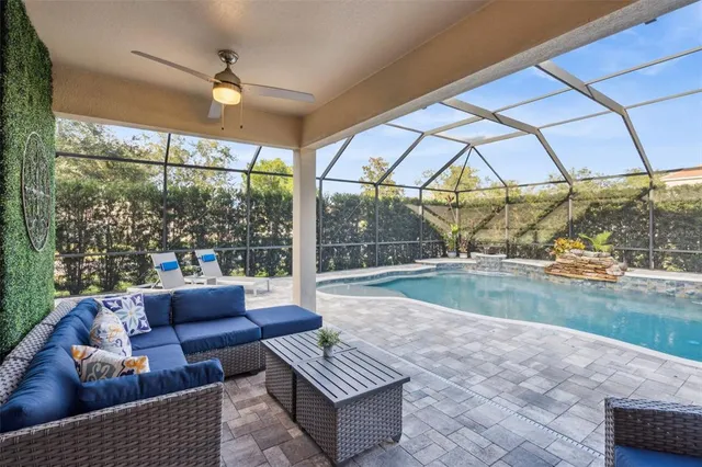 a living room with furniture and a floor to ceiling window