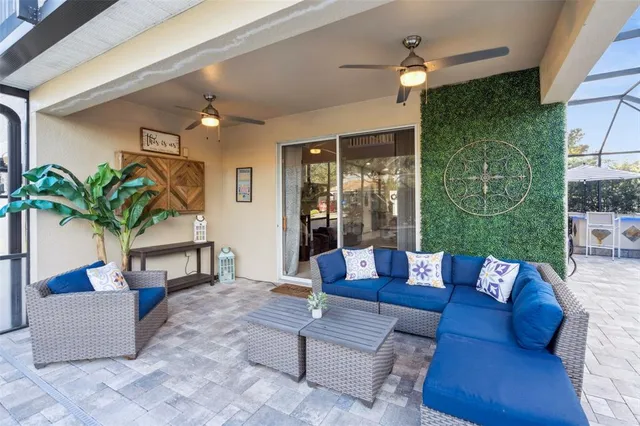 a living room with patio furniture and a potted plant