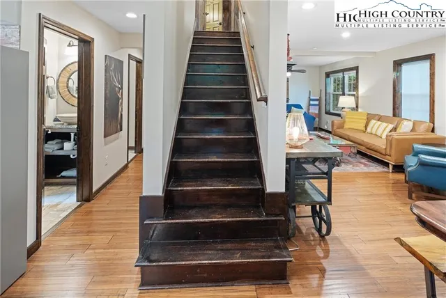 a living room with a bed furniture and a flat screen tv
