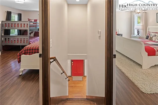 a bedroom with furniture and a large window