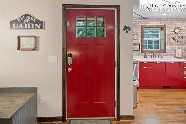 a kitchen with stainless steel appliances granite countertop a refrigerator a stove and white cabinets with wooden floor