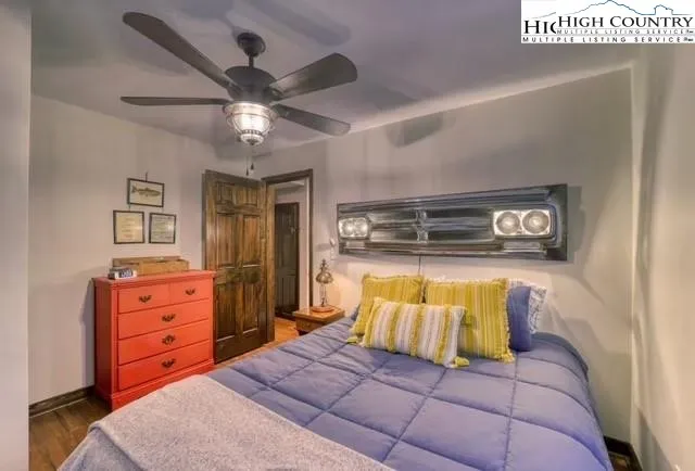 a view of a brick house with a small yard and deck