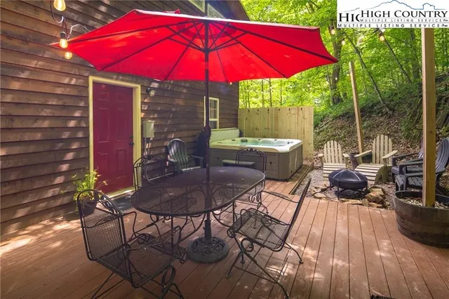 a view of a patio with table and chairs under an umbrella