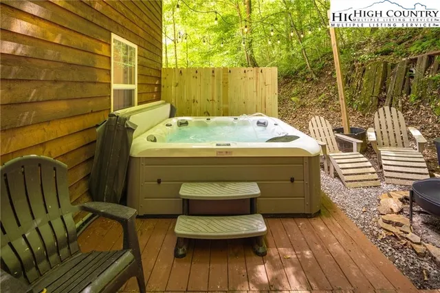a view of a backyard with table and chairs under an umbrella