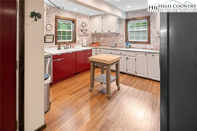 a kitchen with stainless steel appliances a sink stove and cabinets