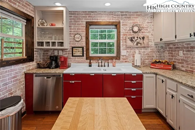 a kitchen with stainless steel appliances granite countertop a sink stove microwave and cabinets