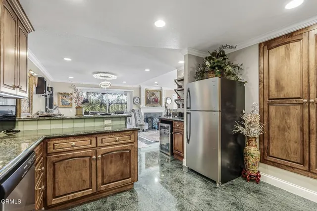 a kitchen with refrigerator a microwave and stove