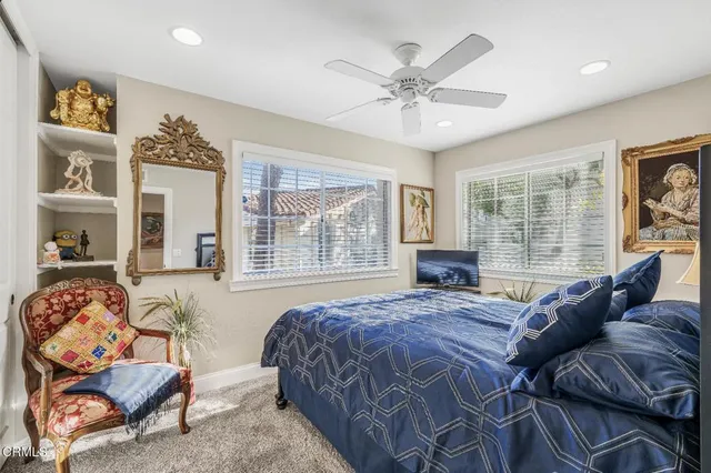 a large bedroom with a bed and wooden floor