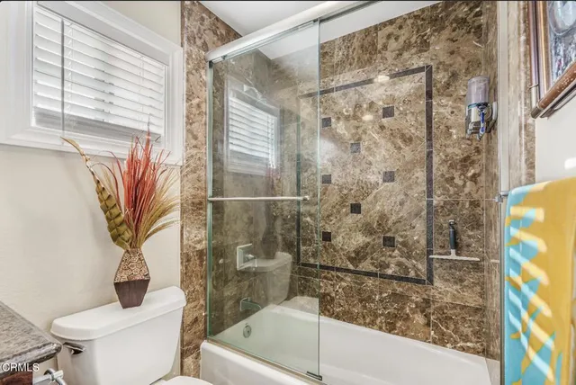 a bathroom with a shower and a toilet