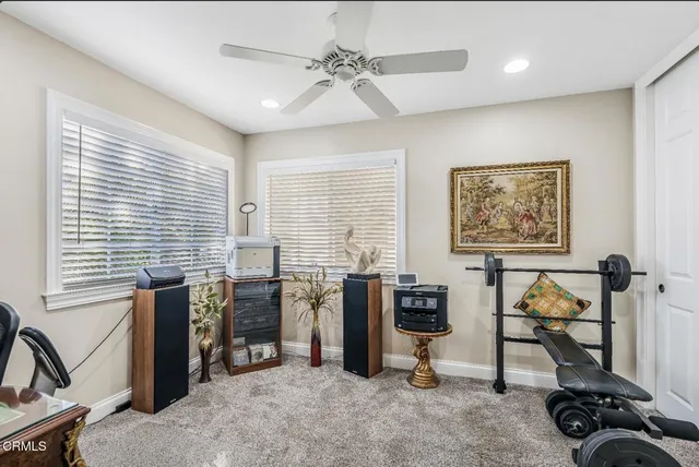 a view of a livingroom with workspace and a window
