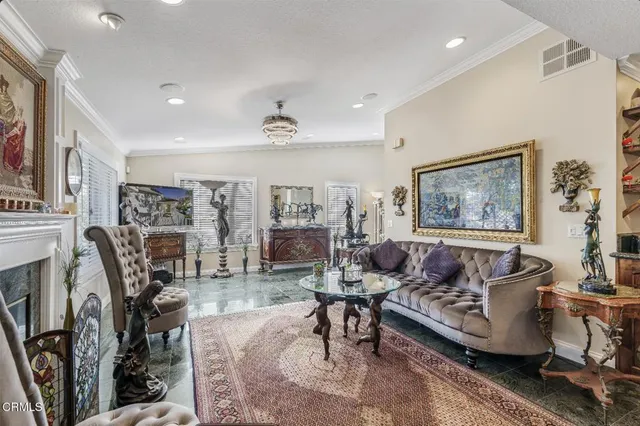 a living room with fireplace furniture and a rug