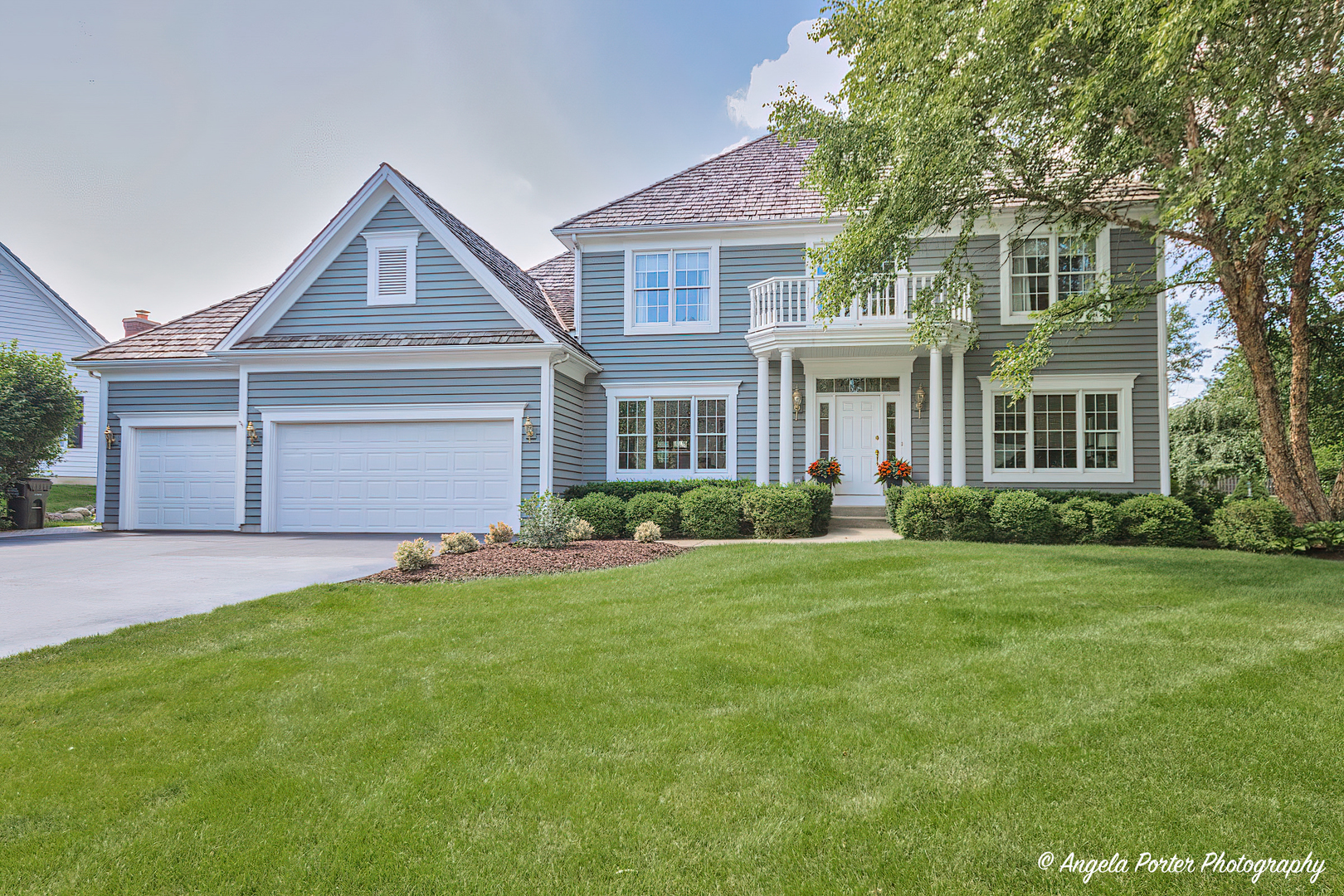a front view of a house with a garden and yard