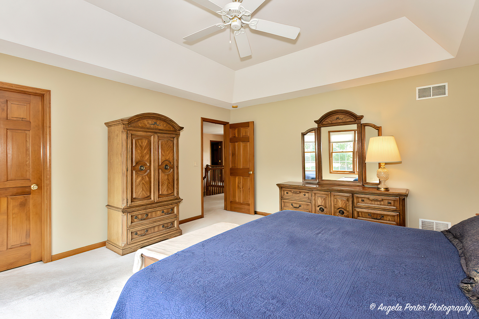 471 White Oaks Drive Cary, IL 60013 - Photo 26 of 39 a bedroom with a bed and a chandelier