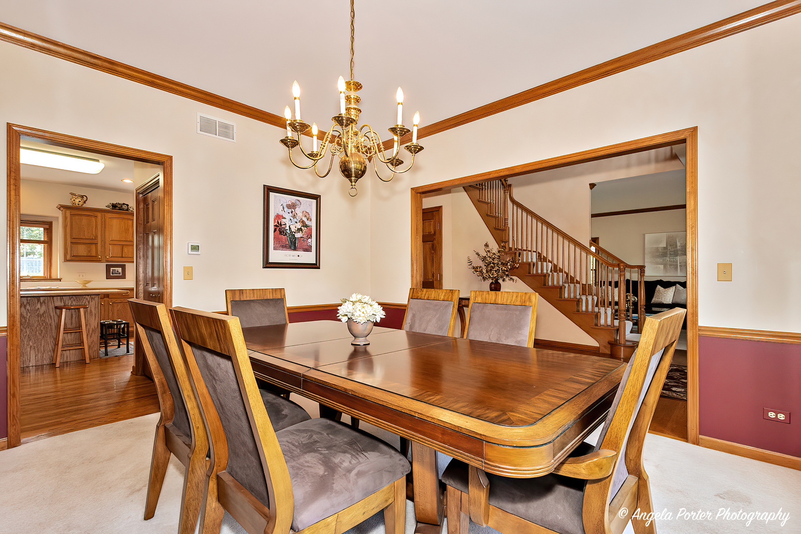 471 White Oaks Drive Cary, IL 60013 - Photo 8 of 39 a dining room with furniture a chandelier and wooden floor
