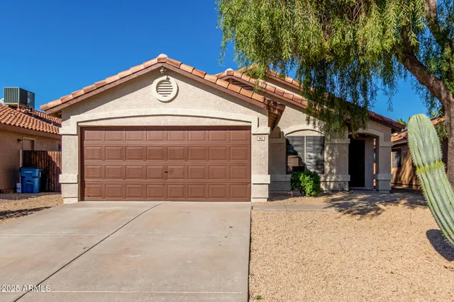 a view of a house with a yard and garage
