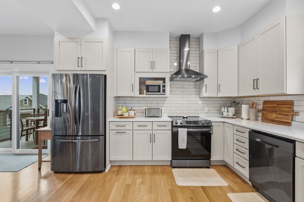 340 Main Street Everett, MA 02149 - Photo 11 of 42 a kitchen with a stove top oven and refrigerator