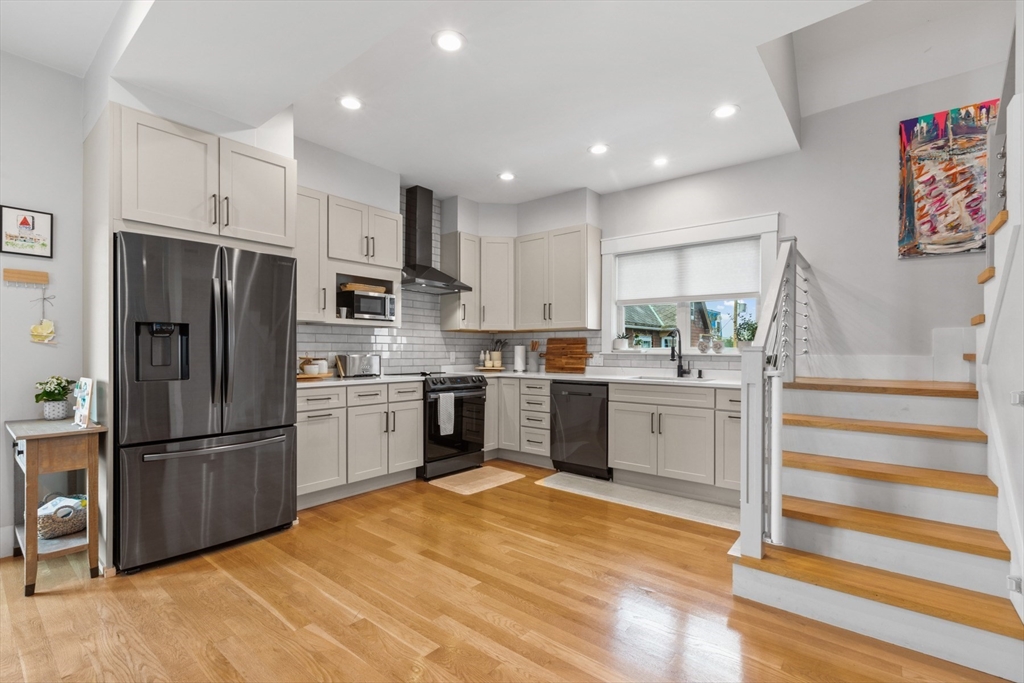 340 Main Street Everett, MA 02149 - Photo 12 of 42 a kitchen with granite countertop stainless steel appliances and refrigerator