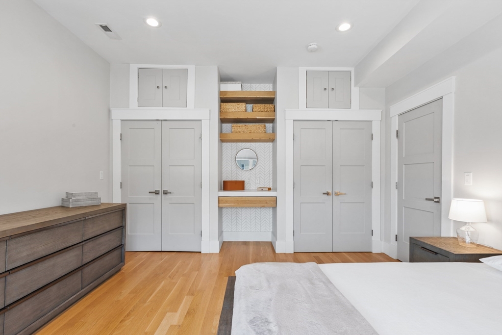 340 Main Street Everett, MA 02149 - Photo 19 of 42 a bedroom with a bed and a chandelier