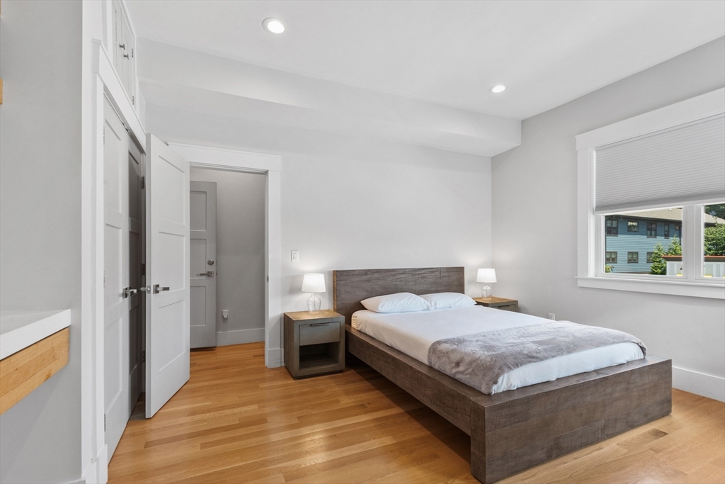 340 Main Street Everett, MA 02149 - Photo 21 of 42 a bedroom with a bed and a table