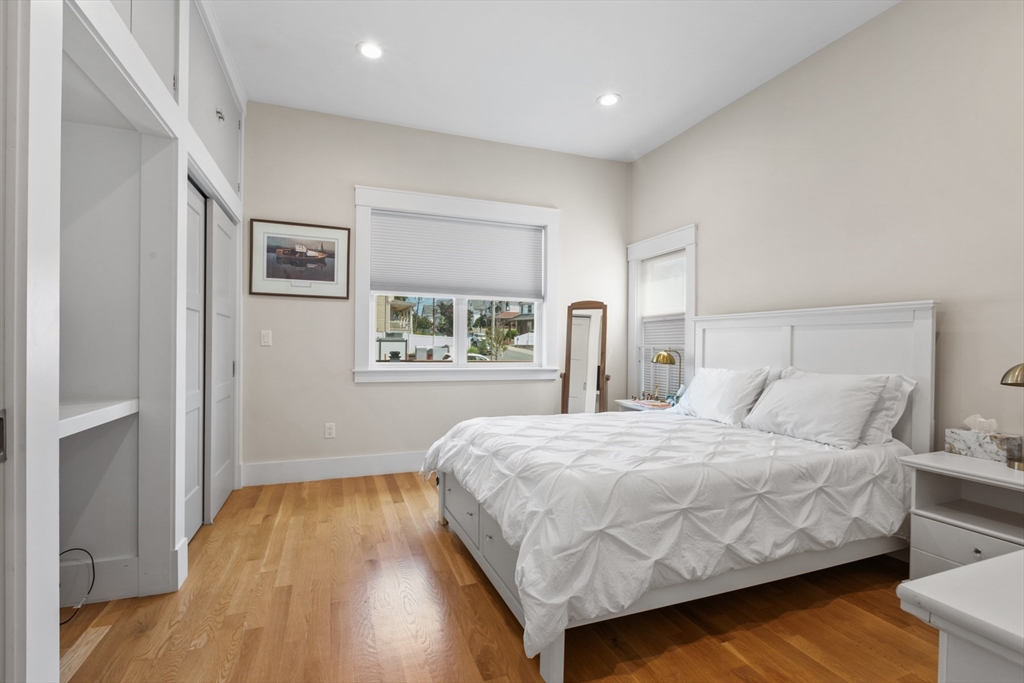 340 Main Street Everett, MA 02149 - Photo 26 of 42 a bedroom with a bed and wooden floor