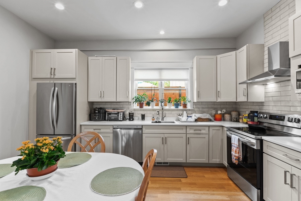 340 Main Street Everett, MA 02149 - Photo 31 of 42 a kitchen with a sink cabinets and stainless steel appliances