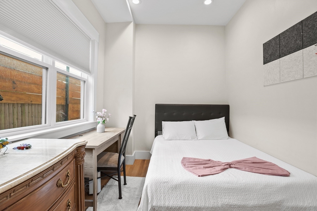 340 Main Street Everett, MA 02149 - Photo 35 of 42 a bedroom with a bed and a table