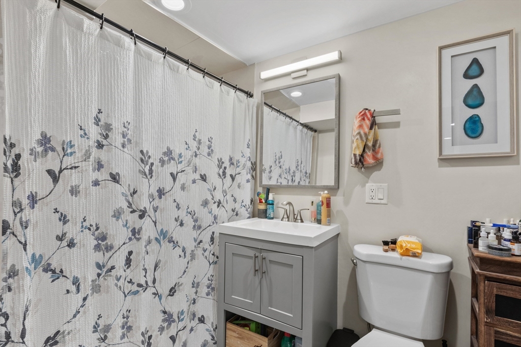 340 Main Street Everett, MA 02149 - Photo 36 of 42 a bathroom with a sink a toilet and a mirror