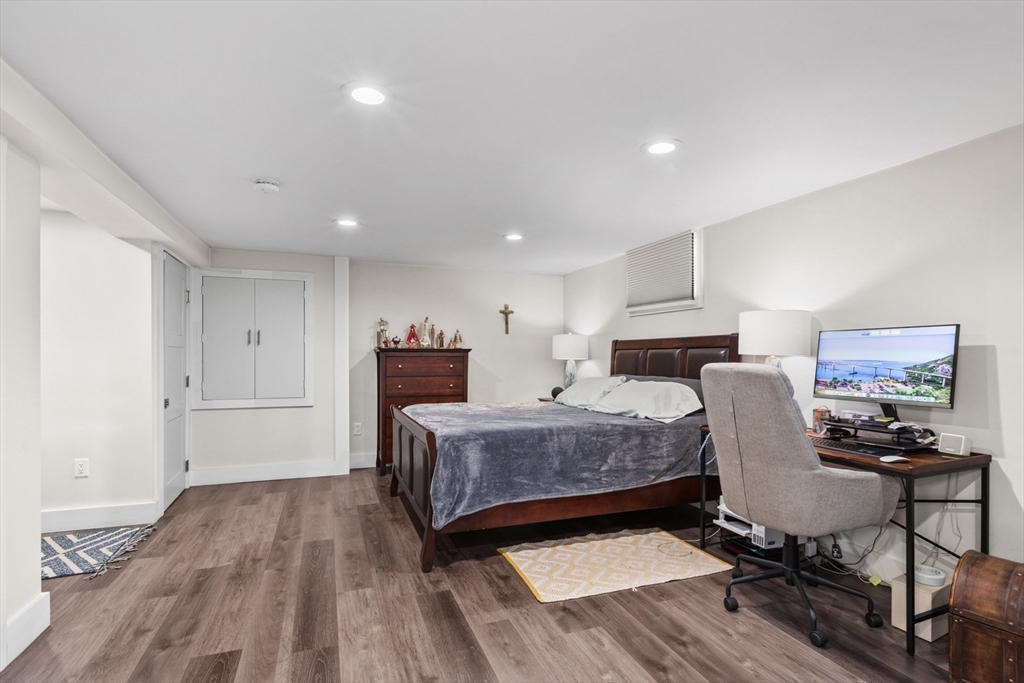 340 Main Street Everett, MA 02149 - Photo 41 of 42 a bedroom with furniture and a wooden floor