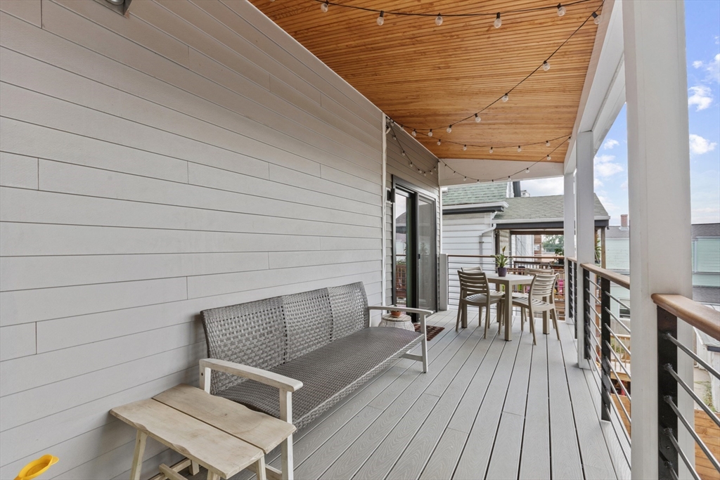 340 Main Street Everett, MA 02149 - Photo 42 of 42 a view of house with deck outdoor seating and wooden floor
