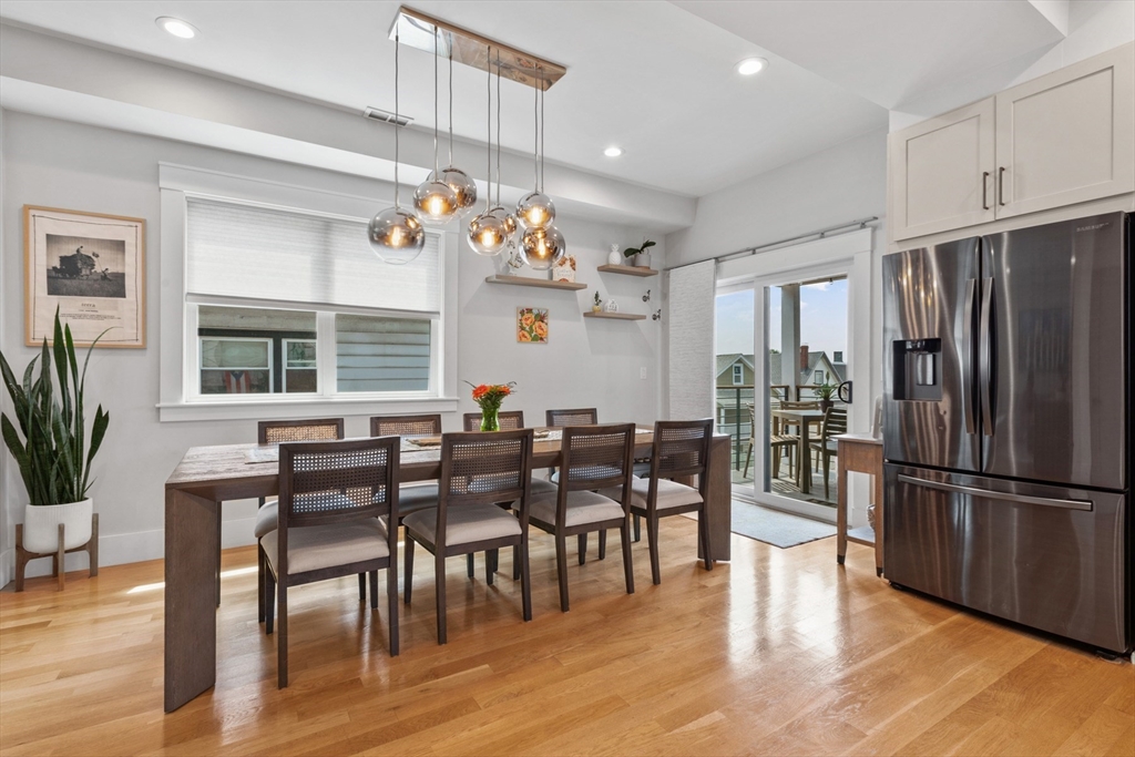 340 Main Street Everett, MA 02149 - Photo 9 of 42 a kitchen with granite countertop stainless steel appliances dining table and chairs