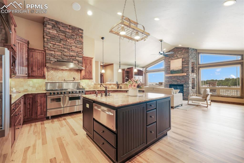7830 Tannenbaum Road Colorado Springs, CO 80908 - Photo 11 of 50 a kitchen with stainless steel appliances granite countertop a stove and a large countertops with cabinets