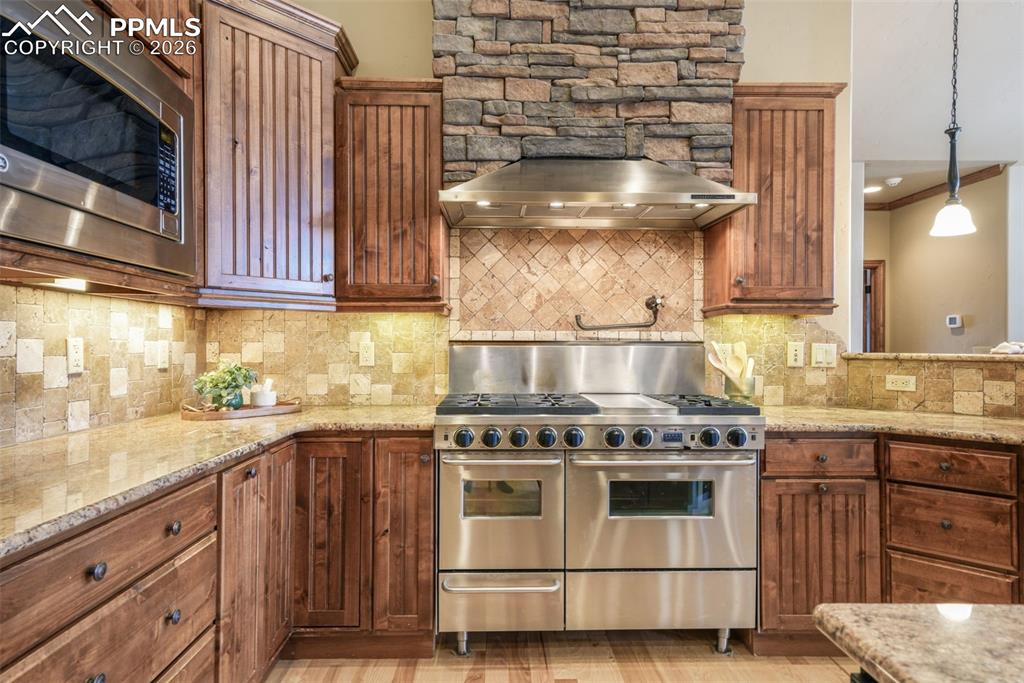 7830 Tannenbaum Road Colorado Springs, CO 80908 - Photo 12 of 50 a kitchen with a stove and a sink
