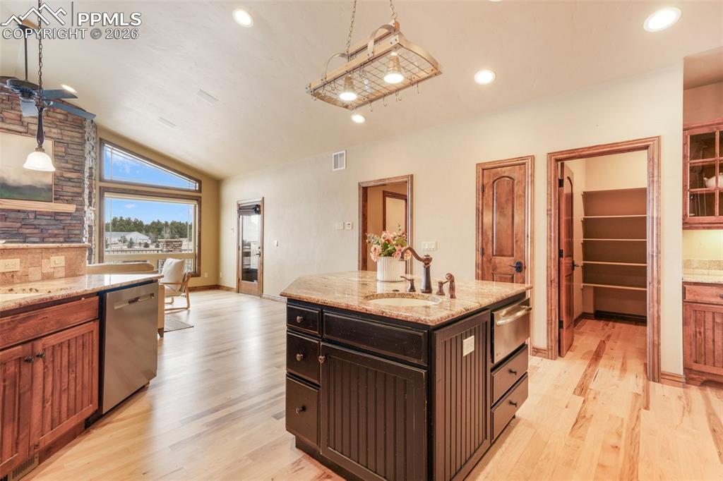 7830 Tannenbaum Road Colorado Springs, CO 80908 - Photo 13 of 50 a kitchen with counter top space a sink appliances and cabinets