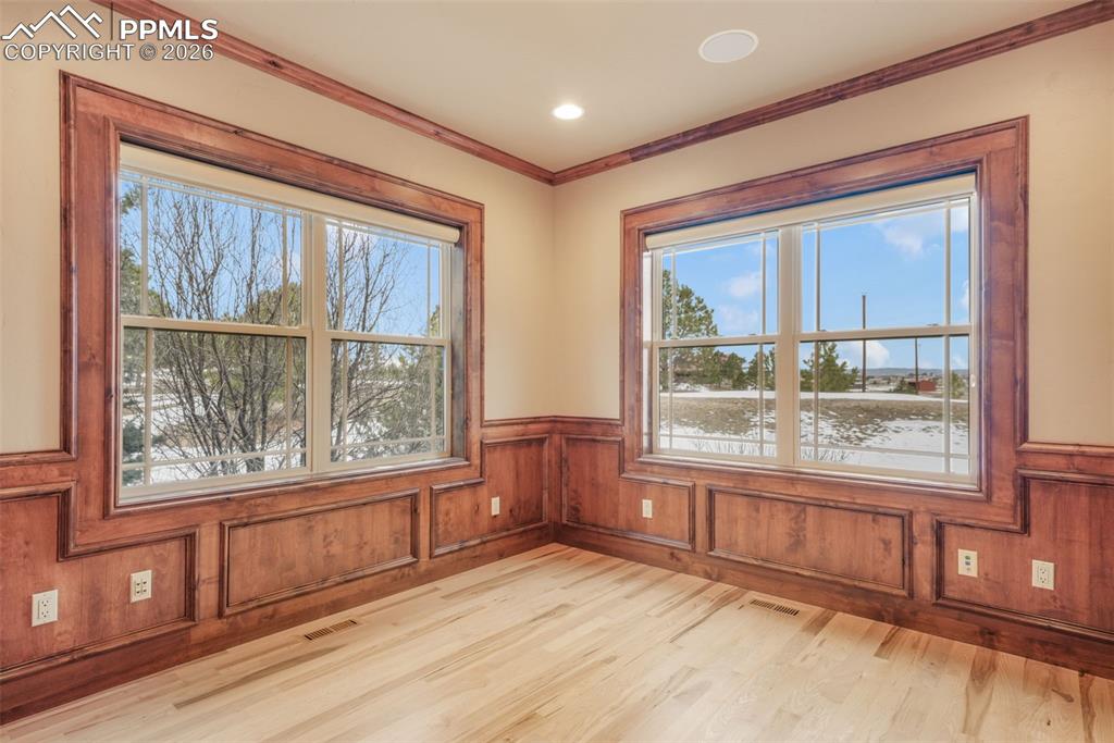 7830 Tannenbaum Road Colorado Springs, CO 80908 - Photo 17 of 50 a view of an empty room with a window and wooden floor