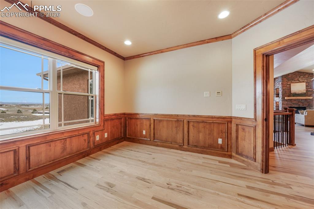 7830 Tannenbaum Road Colorado Springs, CO 80908 - Photo 18 of 50 a view of an empty room with wooden floor and a window