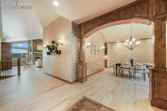 a view of a dining room with furniture and a chandelier