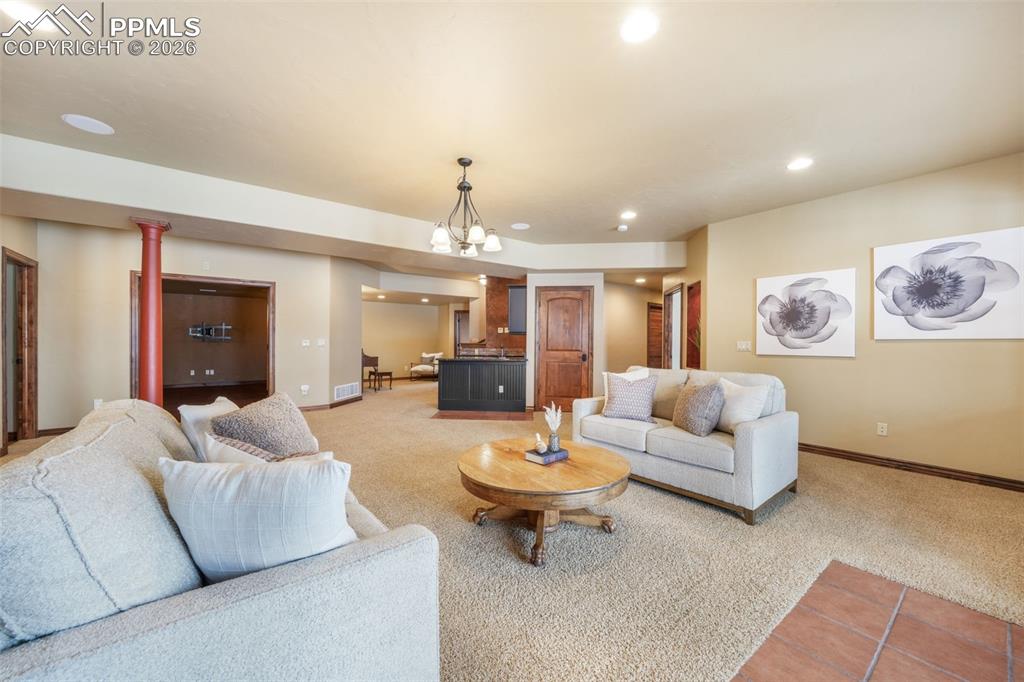 7830 Tannenbaum Road Colorado Springs, CO 80908 - Photo 34 of 50 a living room with furniture and view of kitchen